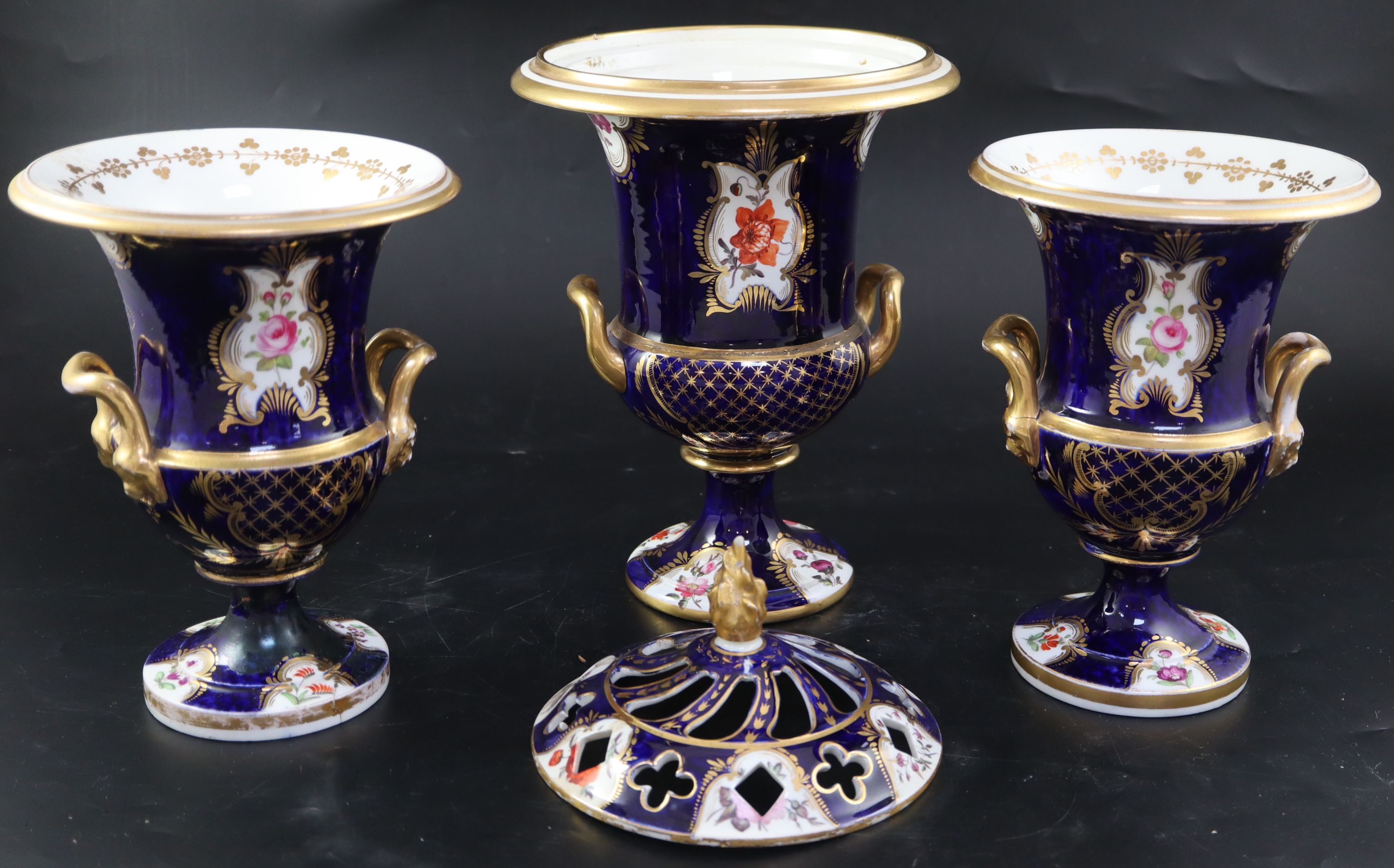 An English porcelain garniture of three vases, c.1830, the central 35cm (a.f.)